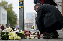 People lay flowers and light candles at the scene of Wednesday's attack on Zamocka Street in Bratislava, 13 October 2022