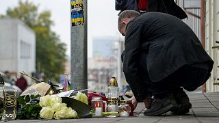 People lay flowers and light candles at the scene of Wednesday's attack on Zamocka Street in Bratislava, 13 October 2022