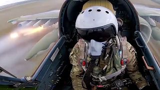 A Russian air force pilot is seen in the cockpit of his Su-25 as it flies on a mission in Ukraine. 
