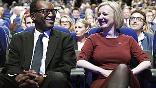 Britain's Chancellor of the Exchequer Kwasi Kwarteng, left and Prime Minister Liz Truss react, during a tribute to the late Queen Elizabeth II at the start of the Conservative