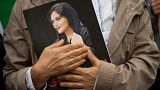 A portrait of Mahsa Amini is held during a rally in Washington calling for regime change in Iran. 