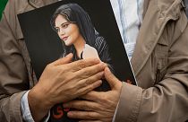 A portrait of Mahsa Amini is held during a rally in Washington calling for regime change in Iran.