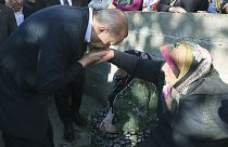 Turkey's President Recep Tayyip Erdogan kisses the hand of a miner's mother after the explosion in Amasra, 15 October 2022