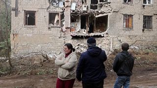 Locals looking at the damaged house after rocket shelling in Kostyantynivka