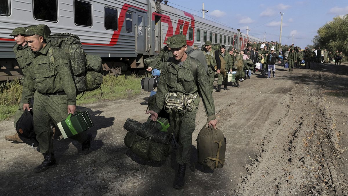 Russian recruits walk to take a train at a railway station in Prudboi, Volgograd region of Russia, 29 September 2022