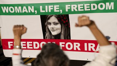 Demonstrators chant slogans while marching during the "March of Solidarity for Iran" in Washington, DC.