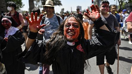 Zombie enthusiasts drag their feet across Santiago