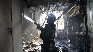 A firefighter works at the site of the burning after shelling in Donetsk.