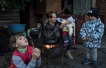 Margaryta Tkachenko feeds her 9-month-old daughter Sophia in the recently liberated town of Izium, Ukraine, on Sept. 25, 2022.