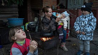 Margaryta Tkachenko feeds her 9-month-old daughter Sophia in the recently liberated town of Izium, Ukraine, on Sept. 25, 2022.