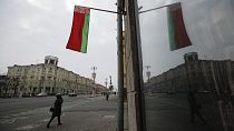 A Belarusian national flag flutters over a street in Minsk in February 2022