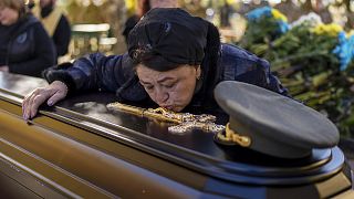 Tatiana Alexeyevna mourns over the coffin of her son Colonel Oleksiy Telizhenko during his funeral in Bucha, 18 October 2022