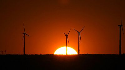 The sun sets on wind turbines in Sterling City, Texas, Thursday, April 2, 2009.
