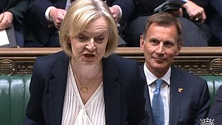 Liz Truss speaking in front of Britain's Chancellor of the Exchequer Jeremy Hunt (back) during Prime Minister's Questions in the House of Commons, London, October 19, 2022.