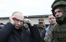 Russian President Vladimir Putin puts on protective glasses as he visits a training centre for mobilised reservists in Ryazan Region, 20 October 2022