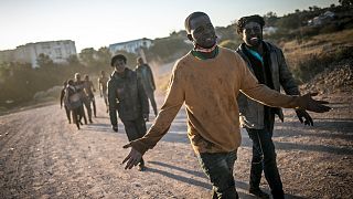Migrants arrive on Spanish soil after crossing the fences separating the Spanish enclave of Melilla from Morocco, in Melilla, Spain.