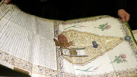 A Pantokrator monk holds a manuscript at the library of Pantokrator Monastery in the Mount Athos, northern Greece.