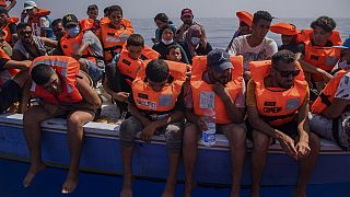 A group thought to be migrants from Tunisia aboard a precarious wooden boat waiting to be assisted by a team of the Spanish NGO Open Arms, 2021.