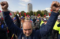 A man clenches his fists during a protest outside the government headquarters in Bucharest, 20 October 2022