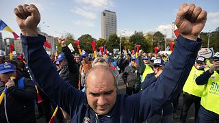 A man clenches his fists during a protest outside the government headquarters in Bucharest, 20 October 2022