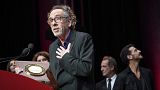 Director Tim Burton delivers a speech after receiving his award during the Lumiere Award ceremony of the 14th Lumiere Festival in Lyon, 21 October 2022