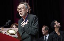Director Tim Burton delivers a speech after receiving his award during the Lumiere Award ceremony of the 14th Lumiere Festival in Lyon, 21 October 2022