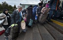 Departees from Kherson gather upon their arrival at the railway station in Dzhankoi, Crimea, 21 October 2022