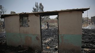 A Yemeni soldier inspects a site of Saudi-led airstrikes targeting two houses in Sanaa.