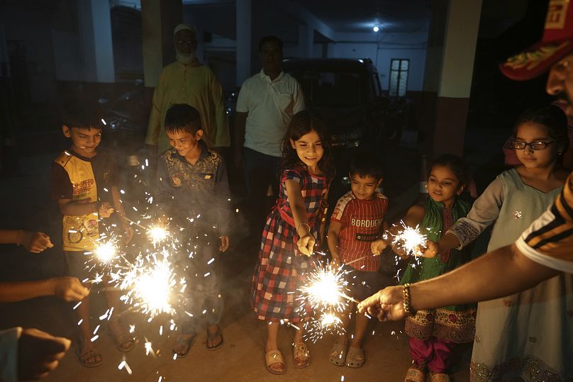 Children light firecrackers to celebrate Diwali, the festival of lights, in Hyderabad, India