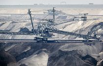 Giant bucket-wheel excavators extract coal at the controversial RWE Garzweiler surface coal mine near Jackerath, west Germany, Thursday, April 29, 2021.