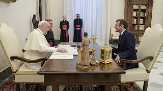 French President Emmanuel Macron, right, talks with Pope Francis during a private audience at the Vatican, Friday, 26 November 2021.