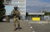 A Russian serviceman stands guard in an area of the Zaporizhzhia Nuclear Power Station, 1 May 2022