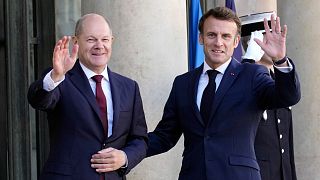 French President Emmanuel Macron, right, welcomes German Chancellor Olaf Scholz at the Elysee Palace in Paris, Oct. 26, 2022. 