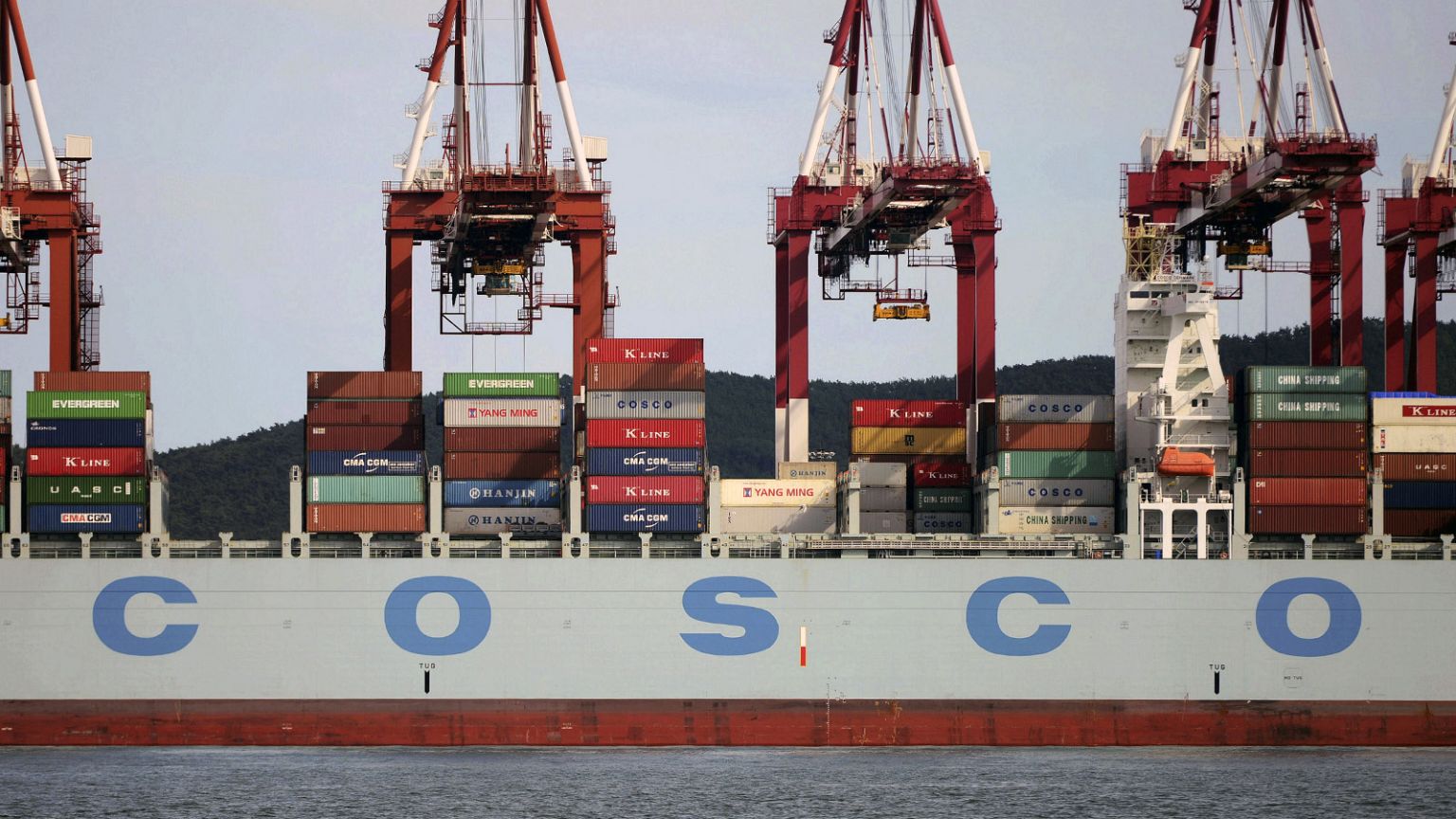 Containers are loaded onto a COSCO container ship at a port in Qingdao in eastern China's Shandong Province in 2016