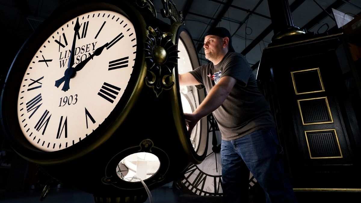 Dan LaMoore works on a Seth Thomas Post Clock at Electric Time Company, Friday, Oct. 23, 2020, in Medfield, Mass., US.