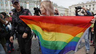 A gay rights activist stands with a rainbow flag during a protest in St. Petersburg in 2015.