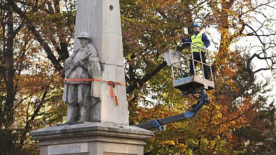 A worker stands on a crane during dismantling of a Red Army monument in Glubczyce, Poland.