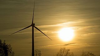 A picture taken on December 9, 2016 shows a wind turbine at sunset in Mardyck, near Dunkirk, northern France.