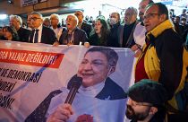متظاهرون يحملون لافتة تحمل صورة رئيسة نقابة الأطباء التركية خلال مظاهرة ضد اعتقالها في أنقرة.