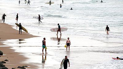 Surfers on the beach at the Basque coast in Biarritz, southwestern France, Thursday, Oct. 27, 2022. 