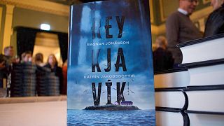 Iceland’s Prime Minister Katrin Jakobsdottir (L) and Icelandic author Ragnar Jonasson