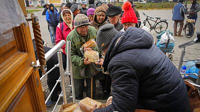 Local residents stand in line waiting for free bread from volunteers in Bakhmut, the site of the heaviest battle against the Russian troops in the Donetsk region, Ukraine