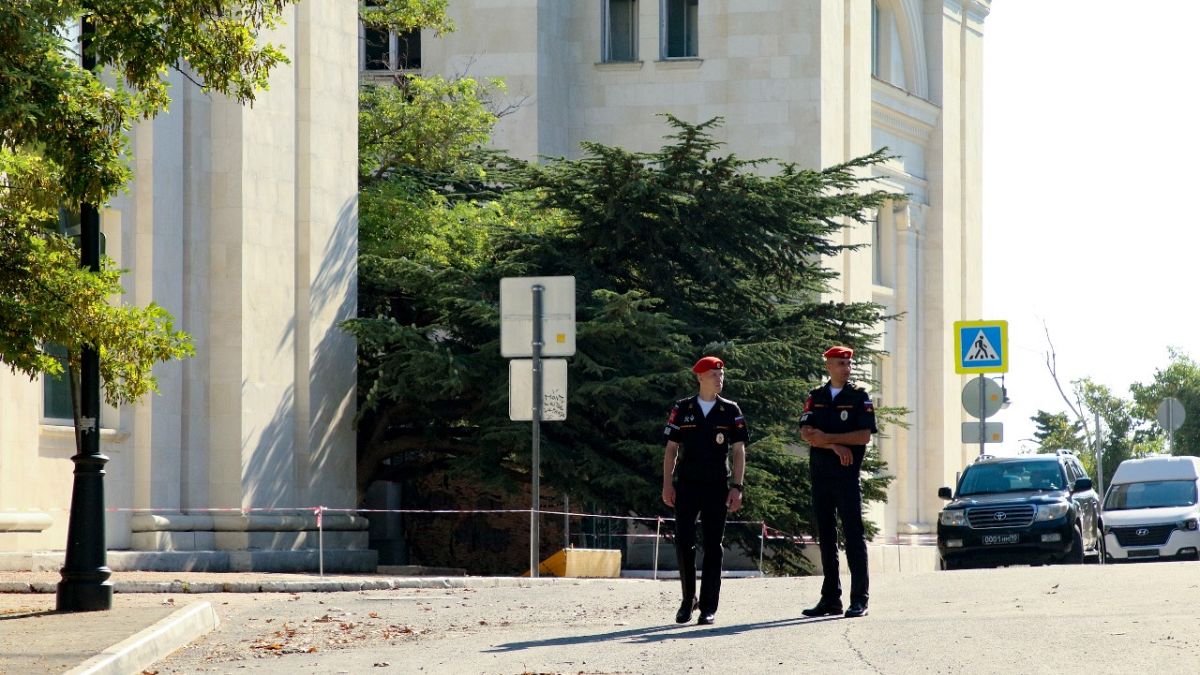 Russian soldiers guard the headquarters of Russia's Black Sea Fleet in Sevastopol, Crimea, Sunday, July 31, 2022, following an explosion that injured six people.