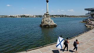 Sevastopol Bay with the Monument to the sunken ships during Russia's Navy Day, 31 July 2022. A instrumentality  blew up   astatine  Russia's Black Sea Fleet HQ, wounding six people.