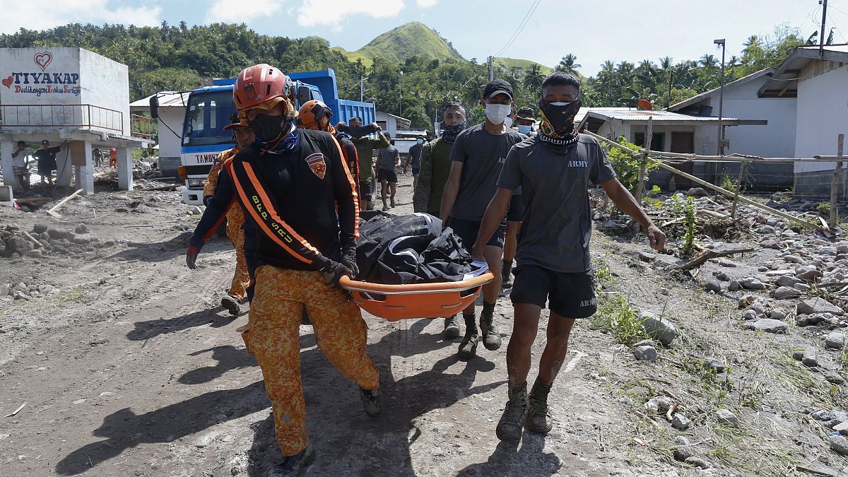 Rescuers carry a body at Maguindanao's Datu Odin Sinsuat town, southern Philippines on Sunday Oct. 30, 2022.