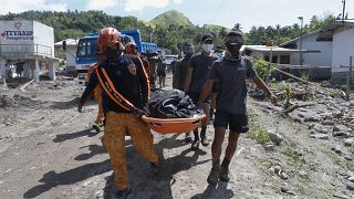 Rescuers carry a body at Maguindanao's Datu Odin Sinsuat town, southern Philippines on Sunday Oct. 30, 2022.
