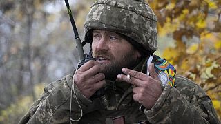 A Ukrainian officer gives commands during the battle in the front line near Bakhmut, 27 October 2022