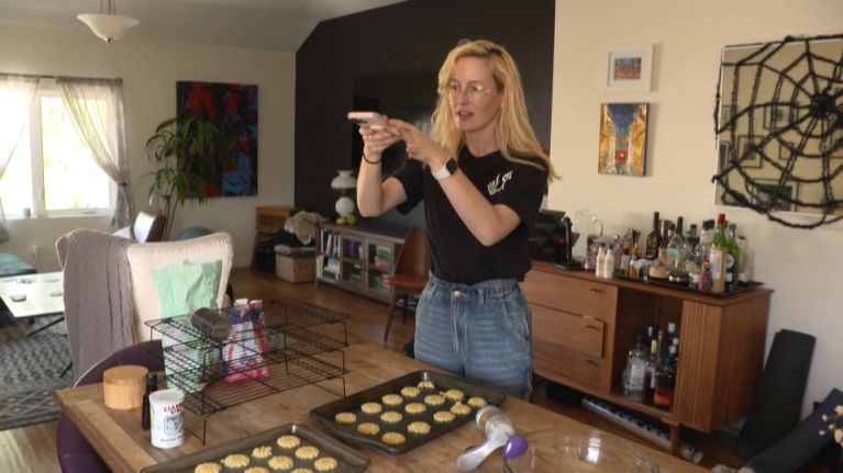 American librarian Rosie Grant filming cookies for her TikTok. 