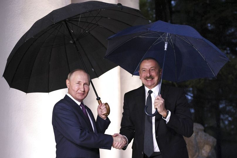 Russian President Vladimir Putin, left, and Azerbaijan's President Ilham Aliyev pose for a photo prior to their meeting in Sochi, Russia, Monday, Oct. 31, 2022.