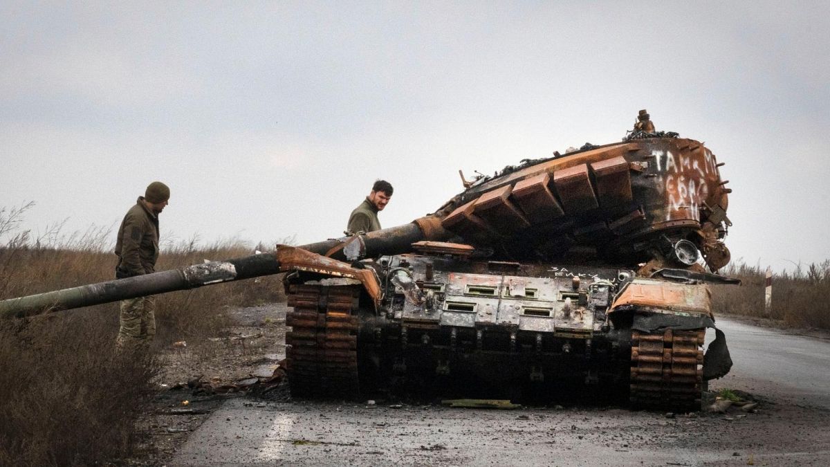 Ukrainian soldiers inspect a damaged Russian tank on a road near the recently retaken village of Kamianka, Kharkiv region, Ukraine, Sunday, Oct. 30, 2022.